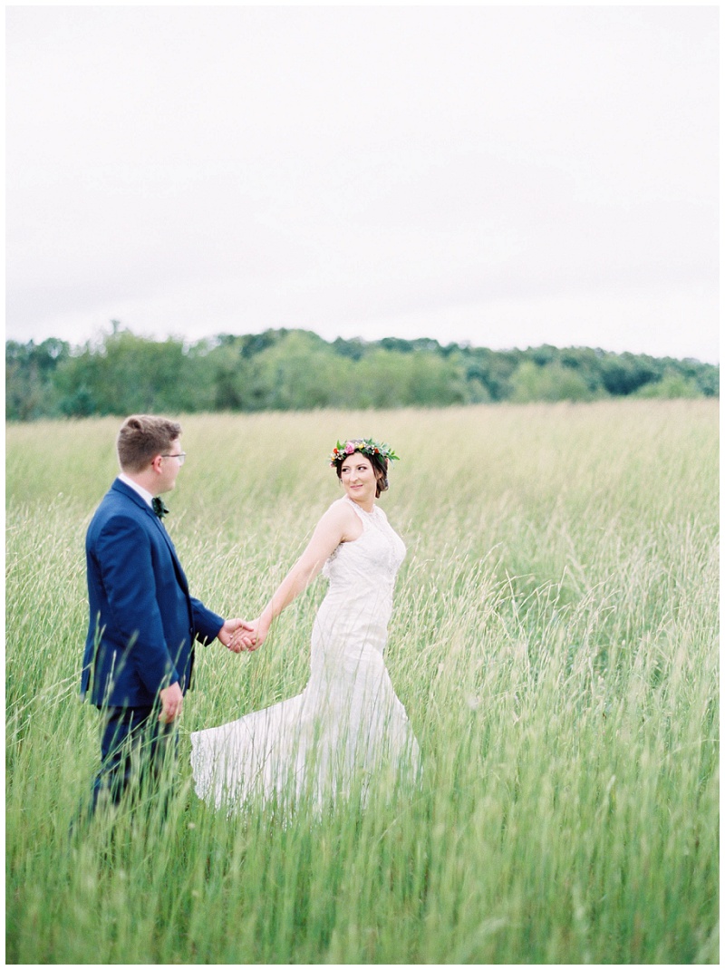 bride and groom in tall grass, Jonesborough TN Storybrook Farm Wedding, Johnson city wedding photographer
